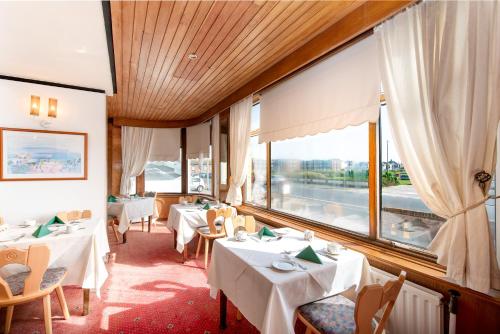 a restaurant with tables and chairs and a large window at The Headlands in Blackpool