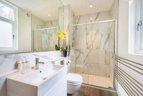 a bathroom with a sink and a shower and a toilet at Marylebone - Crawford Street by Viridian Apartments in London