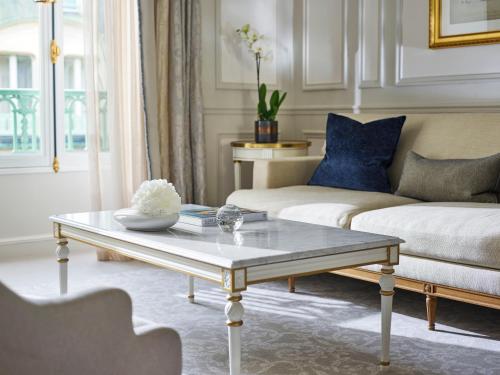 a living room with a coffee table and a couch at Le Meurice – Dorchester Collection in Paris