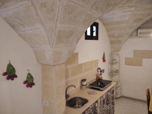 a kitchen with a stone ceiling and a sink at Casa Antica in Fasano