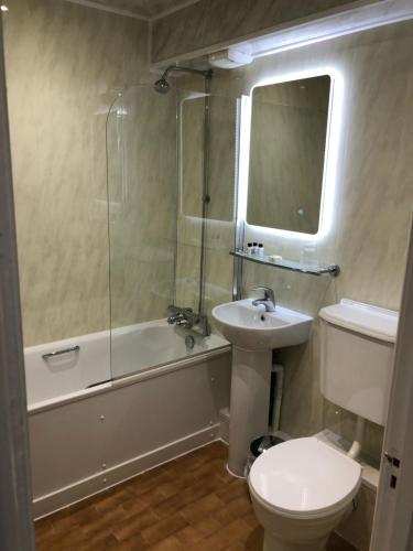 a bathroom with a sink and a toilet and a shower at The Kellbank in Gosforth