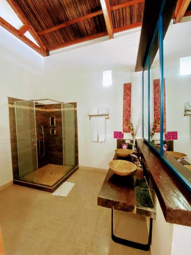 a bathroom with a glass shower and a sink at Casa de Leda, a Kali Hotel in Santa Marta