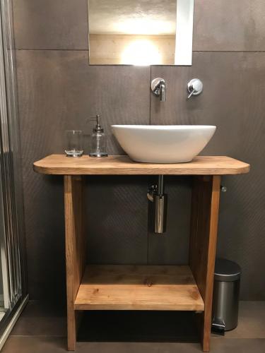 a sink on a wooden table in a bathroom at VIRASOL IN CITTÁ, camera NUVOLE in Cuneo