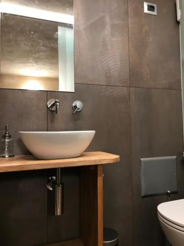 a bathroom with a white sink and a mirror at VIRASOL IN CITTÁ, camera NUVOLE in Cuneo