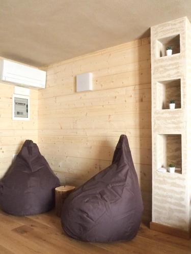 two bean bags in a room with wooden walls at VIRASOL IN CITTÁ, camera NUVOLE in Cuneo