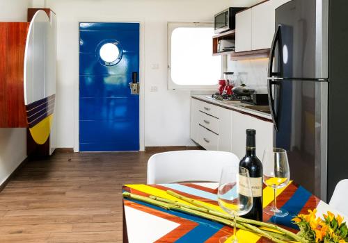 a kitchen with a dining table and a blue door at Puerto Plaza Las Terrenas in Las Terrenas