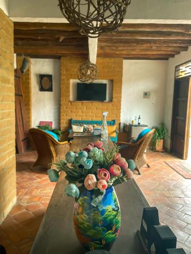 a vase on a table in a living room at Casona CHARA in Barichara