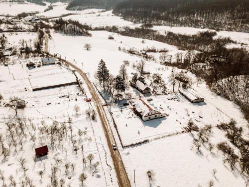 an aerial view of a snow covered field with train tracks at Casa cu Prispa in Sighişoara