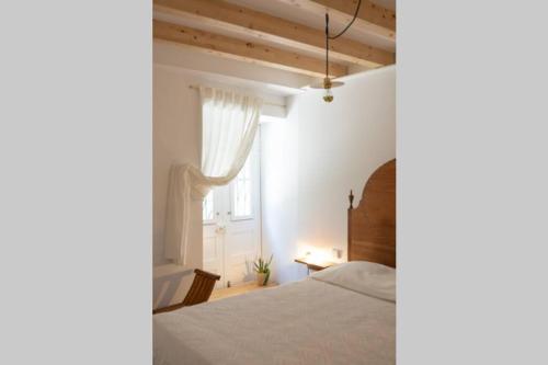 a bedroom with a bed and a window at Pilgrim suite in Vila do Conde