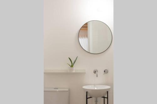 a bathroom with a sink and a mirror on the wall at Pilgrim suite in Vila do Conde