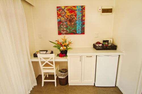 a desk in a room with a painting on the wall at Manuia Beach Resort in Rarotonga
