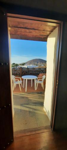 a view of a table and chairs on a balcony at Casa Rural Tamasite in Tuineje