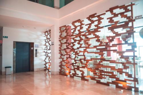 a wall of books on a wall in a room at Hotel Unión Plaza in Montería