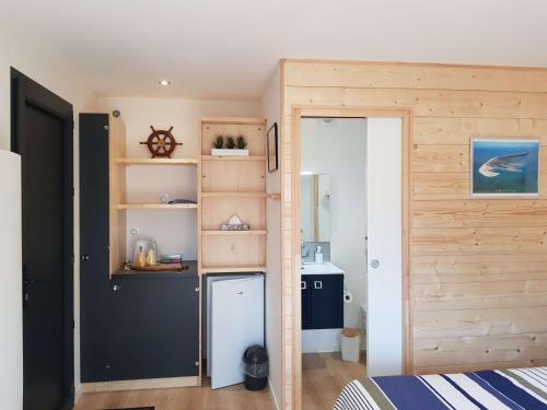 Cette chambre comprend une petite cuisine avec un petit réfrigérateur. dans l'établissement Chambre d'hôtes et Spa de la Presqu'île, à La Faute-sur-Mer