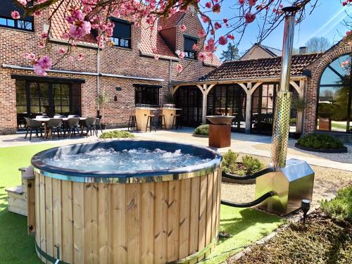 a hot tub in a yard in front of a building at 't Averhuys in Itegem