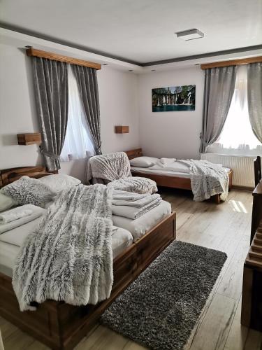 a living room with two beds and a couch at Pansion House Prijeboj in Plitvička Jezera