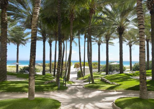 an aerial view of a golf course with palm trees at Grand Beach Hotel Surfside in Miami Beach