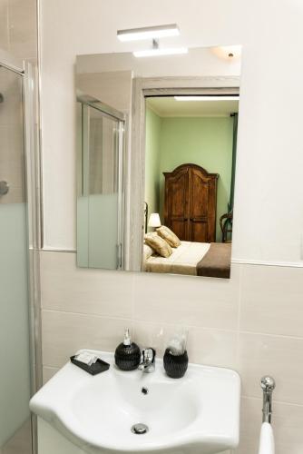 a bathroom with a sink and a mirror at Podere Belvedere in Barberino di Mugello