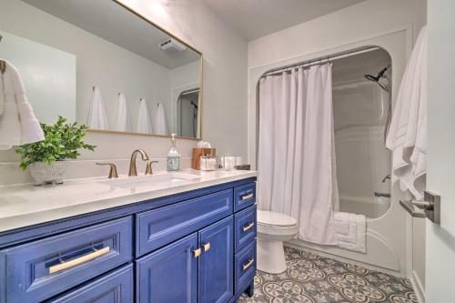 a bathroom with a sink and a toilet and a mirror at Renovated Dtwn Retreat Less Than 1 Mi to Plaza Park! in San Marcos