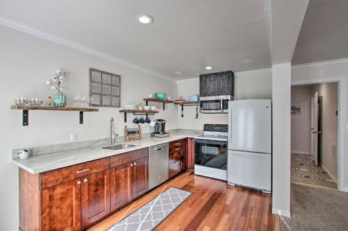 a kitchen with wooden cabinets and a white refrigerator at Convenient Burien Getaway 12 Mi to Dtwn SEA! in Burien