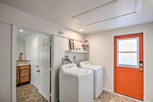 a laundry room with a washing machine and a red door at Convenient Burien Getaway 12 Mi to Dtwn SEA! in Burien