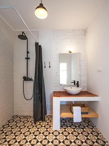 a bathroom with a sink and a mirror at Castelo de Arez in Alcácer do Sal