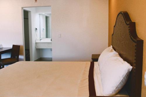 Una cama o camas en una habitación de Estancia Inn
