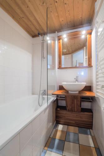 a bathroom with a sink and a shower at Résidence Aiguille Lodge in Les Deux Alpes