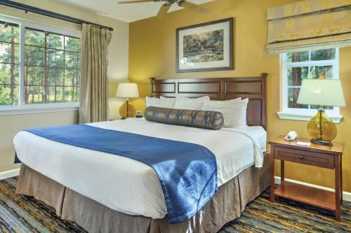 a bedroom with a large bed and two windows at WorldMark Pinetop in Pinetop-Lakeside