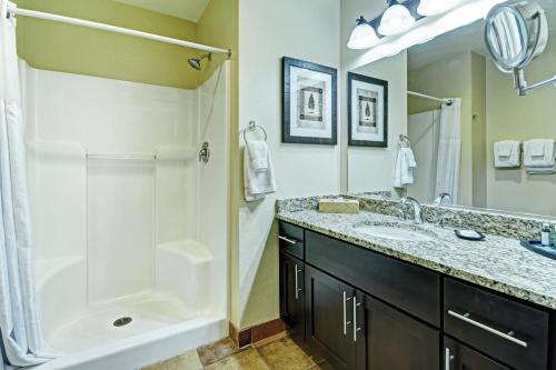 a bathroom with a shower and a sink and a tub at WorldMark Pinetop in Pinetop-Lakeside