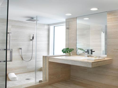 a bathroom with a sink and a shower at Grand Beach Hotel Surfside in Miami Beach