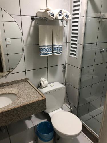a small bathroom with a toilet and a sink at Aptos Gran Lencois Flat Res. in Barreirinhas