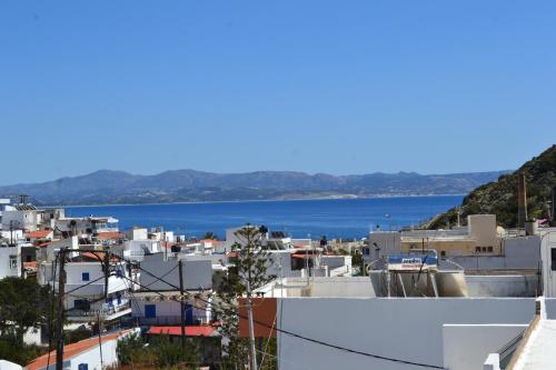 a view of a town with the ocean in the background at Michalis Captain Home in Agia Galini