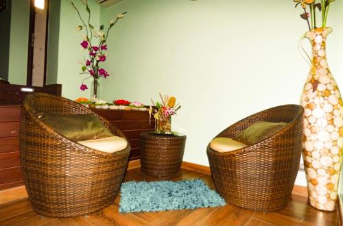 three wicker chairs sitting on the floor in a living room at Hotel Spa Galatea in Burela de Cabo