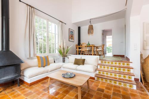 a living room with a couch and a fireplace at Villa Los Dragones in Son Parc