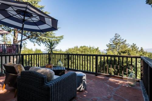 a patio with two chairs and an umbrella at Junior Suite in Los Gatos