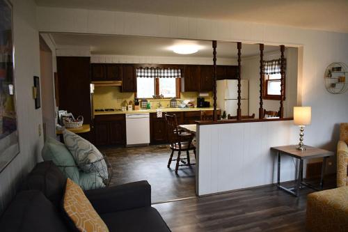 a living room and kitchen with a couch and a table at Brook Road Condo in Goshen