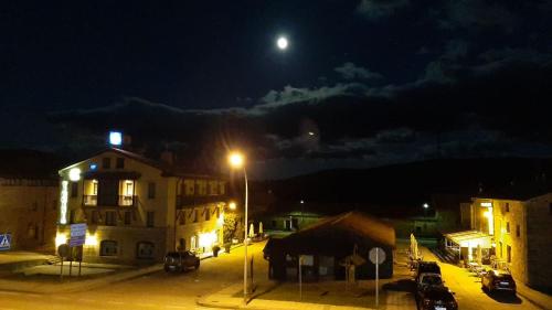 a city street at night with a full moon at Hotel Virginia R.H. in Vinuesa
