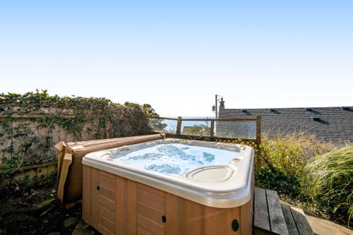 a bath tub sitting on a wooden deck at Blue Wave Heights in Lincoln City