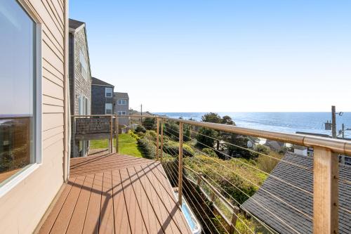 a balcony of a house with a view of the ocean at Blue Wave Heights in Lincoln City