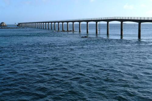 a long bridge in the middle of the water at Maison près de la plage et de la thalasso in Roscoff