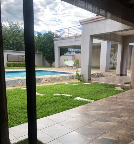 a view of a house with a swimming pool at Homey Guesthouse in Gaborone