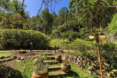 a garden with stairs and plants in a park at Vale do Lajeado - Mountain chalets in Campos do Jordão