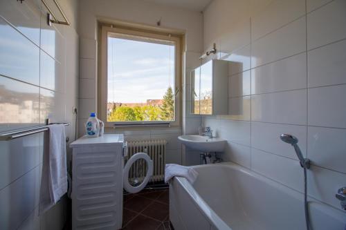 a bathroom with a tub and a sink and a toilet at #centralstation #130qm Hauptbahnhof #netflix in Karlsruhe