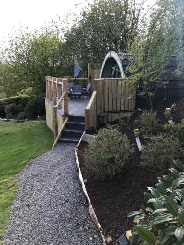 a wooden staircase leading to a garden with a playground at Lough Erne Glamping Pod in Enniskillen