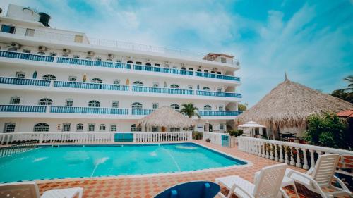 a cruise ship with a swimming pool in front of it at Hotel Kevins in Tolú