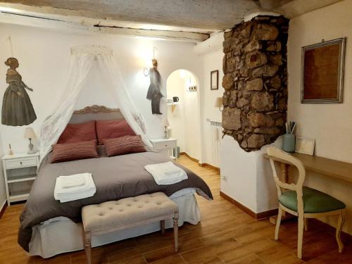 a bedroom with a bed and a table and a chair at Livia's Charming Room in Trevignano Romano