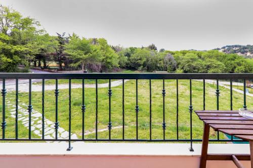 a balcony with a view of a park at Suite Acropolis Serres With Parking Next to Center in Serres