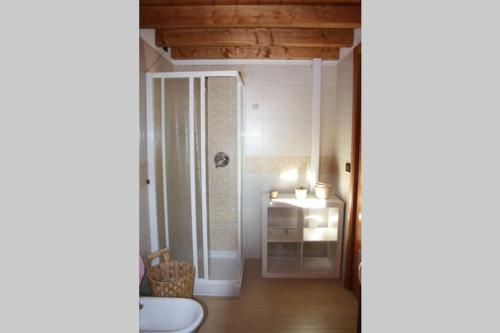 a room with a bathroom with a sink and a mirror at Piscina e vistalago CroceMenaggio CIR 013145-00318 in Menaggio
