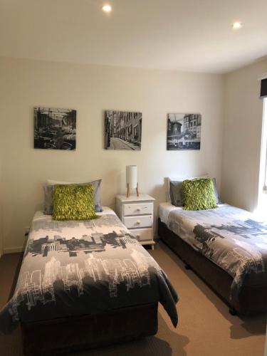 a bedroom with two beds and a window at Chill Apartment in Rye